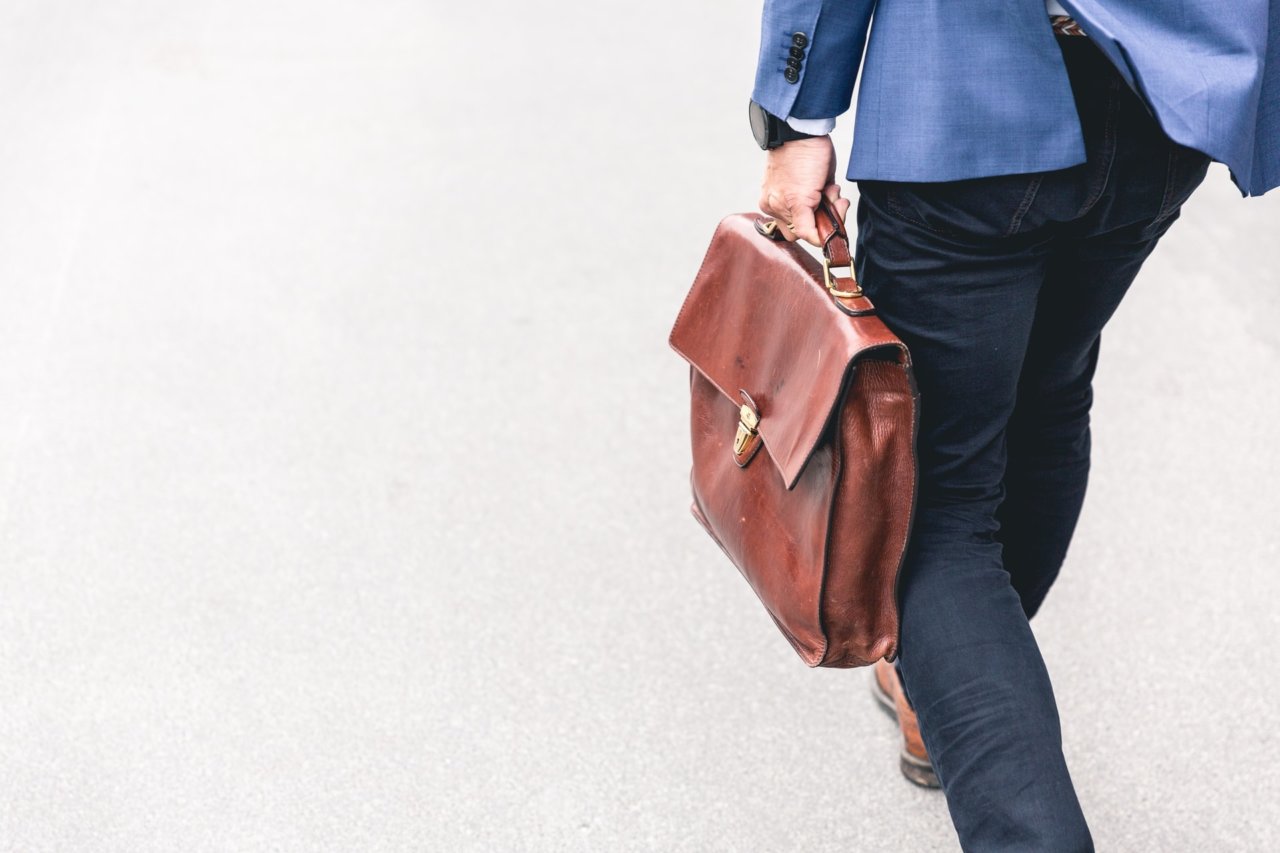 A WordPress SEO Expert Walking With A Briefcase In Hand